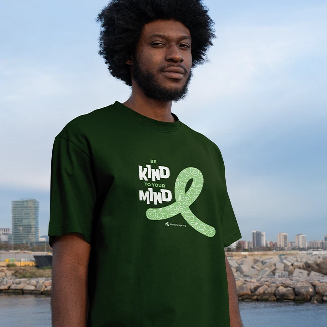 Man wearing shirt with Be Kind to Your Mind logo