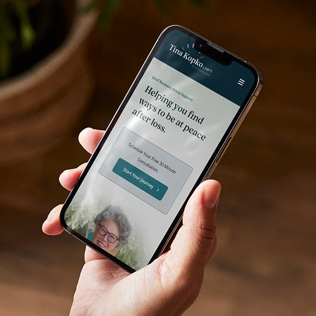 Tina Kopko website shown on a cellphone