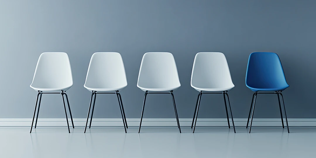 One blue chair and the end of a line of white chairs